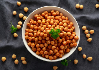 Roasted spicy chickpeas in white bowl. Healthy food