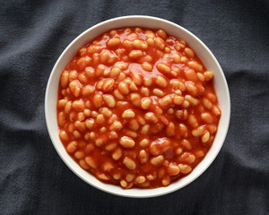 Baked beans in tomato sauce in white bowl