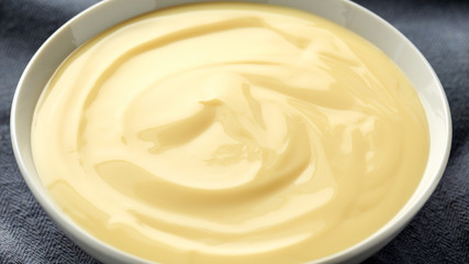 Bowl of vanilla custard on rustic background - obrazy, fototapety, plakaty