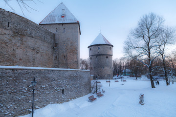 Medieval wall with towers. Snowy old town of Tallinn