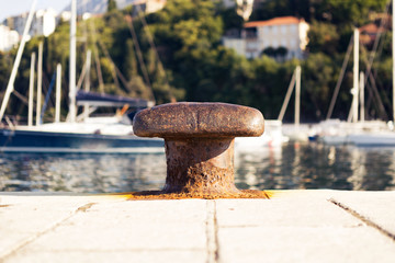 An old mooring bollard at commercial seaport.