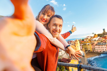 Vernazza, national park Cinque Terre, Liguria, Italy, Europe. Tourists happy couple taking selfie photo on camera - obrazy, fototapety, plakaty