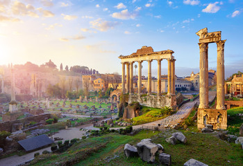 Roman Forum in Rome, Italy. Antique structures with columns. Wrecks of ancient italian roman town. Sunrise above famous architectural landmark.