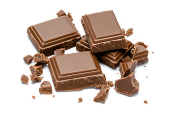 Milk organic chocolate pieces isolated on white background