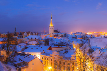 Rooftop view of old town of Tallinn, Estonia. Snowy night fairytale