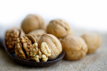 walnuts in wood spoon  on ramie sheet