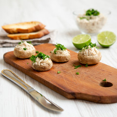 Mushroom and chicken puree with lime and toasts on a white wooden table, low angle view. Close-up. Selective focus.