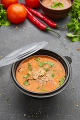 Traditional Georgian soup Kharcho with meat and rice on dark stone background