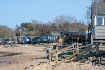 Fototapeta na wymiar Maningtree Suffolk Uk - 1 April 2019: Row of large wooden beachside homes on beach