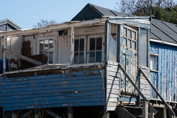 Fototapeta na wymiar Run down blue wooden coastal shack