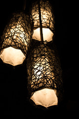 Three decorated lantern in the night. Evening illumination. Light and darkness. Electricity...