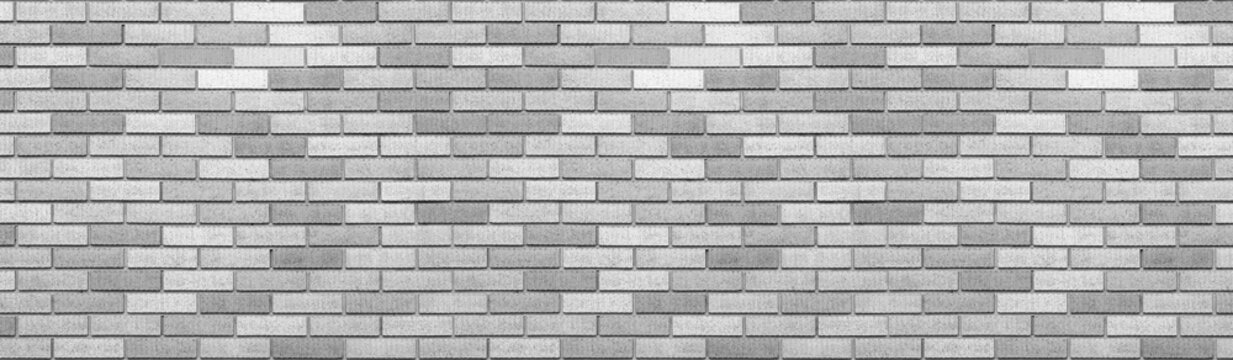 Fototapeta Abstract gray brick wall texture background. Horizontal panoramic view of masonry brick wall.