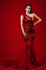 Woman Red Dress, Fashion Model Elegant Gown, Young Girl Beauty Portrait over Red Background . ...