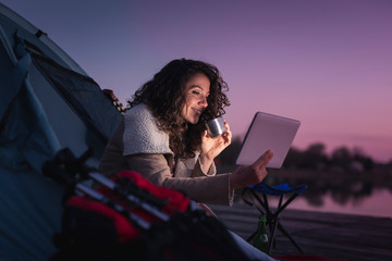 Woman camping by the lake