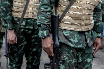 The Army soldier stand in row they are wear hat and wear Military vest.