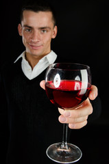 The sexy guy drinks wine.