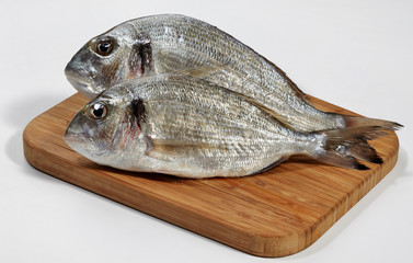 Fresh dorado fish on wooden cutting board