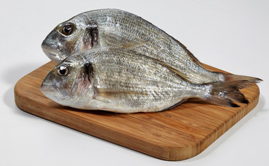 Fresh dorado fish on wooden cutting board