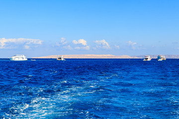 View of Red sea and white yachts on horizon near Hurghada, Egypt