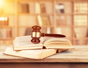 Books and wooden gavel on table. Justice concept