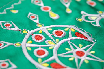 berbere embroidery design on green cloth