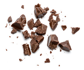 Dark organic chocolate pieces isolated on white background