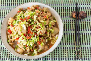 Traditional Asian appetizer - spicy sliced grilled pork skin. Chinese and Thai dish.