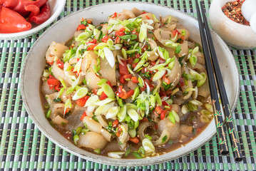 Traditional Asian appetizer - spicy sliced grilled pork skin. Chinese and Thai dish.