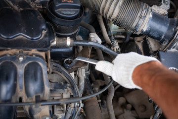 mechanic men with wrench repairing car engine at