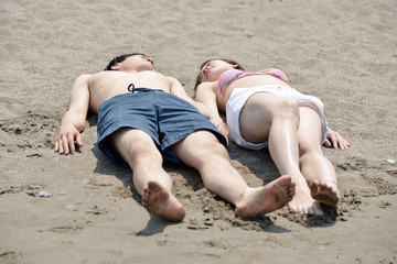 ビーチで寄り添う若いカップル