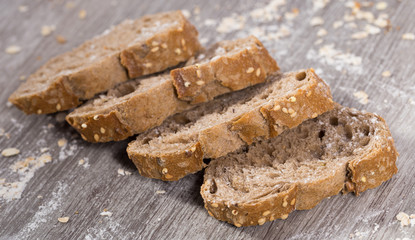 fresh slices of rye bread on wooden surface