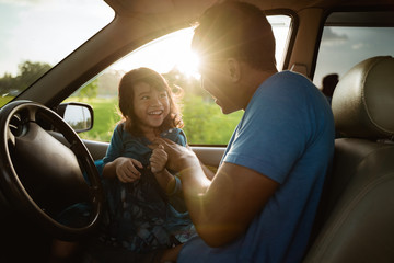 father daughter playing in the car together