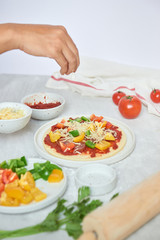 Preparing individual pizzas from pizza bar