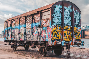 The carriage painted with different graffiti next to the river in Copenhagen, Denmark . March 3,...
