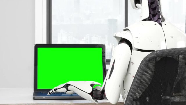 Robot using laptop with copy space green screen
