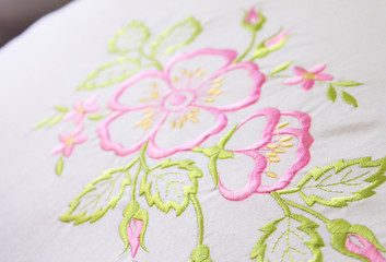 colorful embroidery design on a white pillow