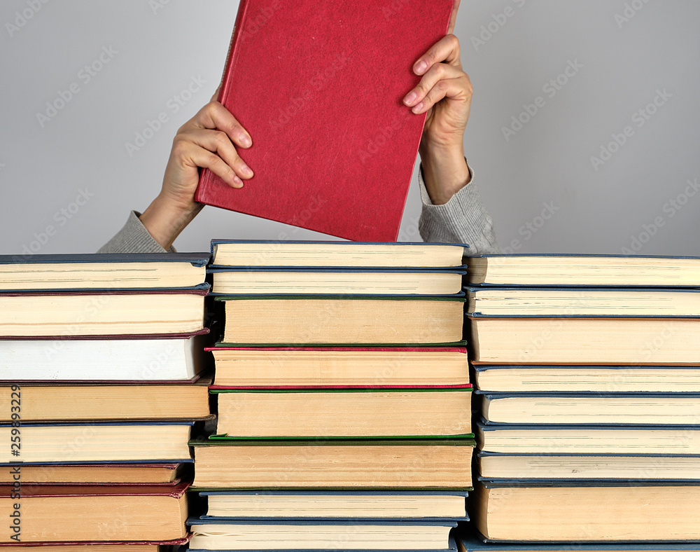 Poster stack of different books on a gray background