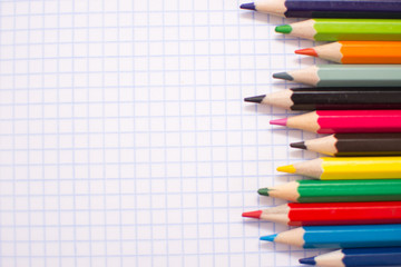 Multicolored pencils for children's creativity on a white background. Place for text.