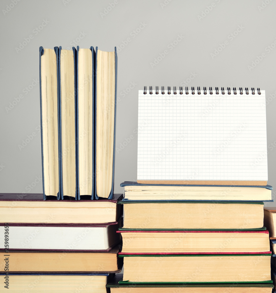 Aufkleber open blank notebook is standing on the stack of books