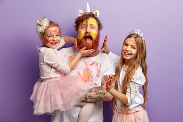 Overloaded fatigue single father with ginger beard, cries desperately, has fun with two female...