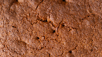 freshly baked cake with beautiful ruddy crust close-up as background