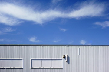 Outside wall of warehouse and blue sky                                 