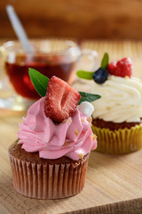 Two cheesecakes and cup of tea on the wooden table. Morning breakfast.