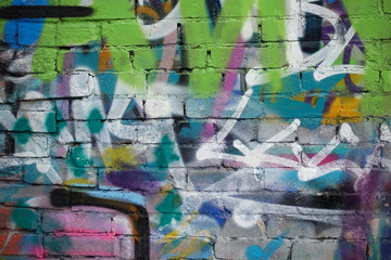 Street art. Abstract background. Chaotically painted brick walls with multi-colored paint