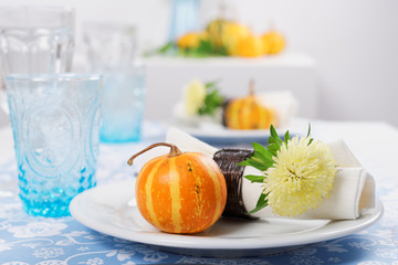 Thanksgiving table setting with decorative pumpkins