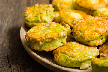 homemade baked scone cakes from fresh ramson leaves and cheese, old wooden texture