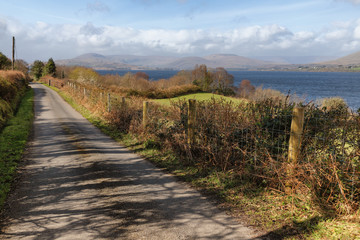 Fototapeta na wymiar Mountain, road, lake and vegetation at Western way trail in Lough Corrib