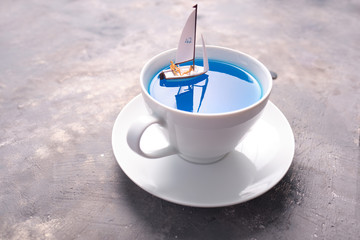 Dreams about holidays. the couple is sailing in a cup. miniature world