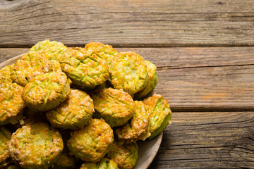 homemade baked scone cakes from fresh ramson leaves and cheese, old wooden texture