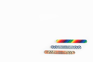 Multicolored used pedicure manicure nail files on white isolated background